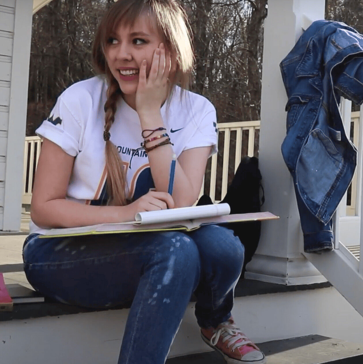 Abigail writing on the front porch